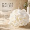 Fleur de douche XXL beige a bordure de pompons, posee sur un plan de salle de bain